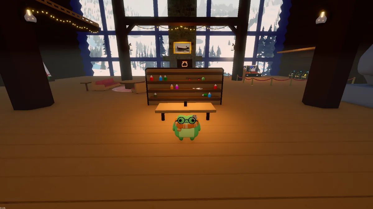 The sled editing table inside the lodge, in front of shelves holding coloured jars and trinkets.
